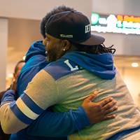 Two event attendees giving each other a hug in greeting